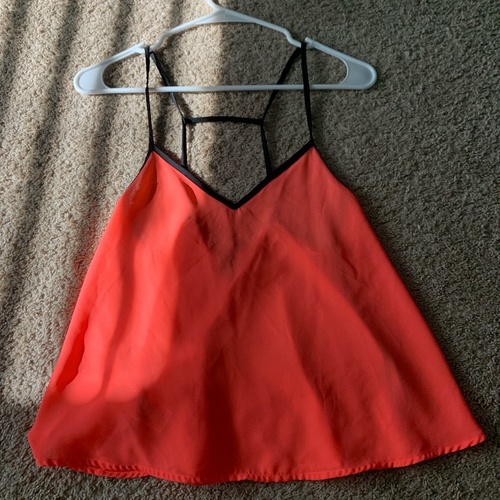 hot pink blouse with black trim and open back